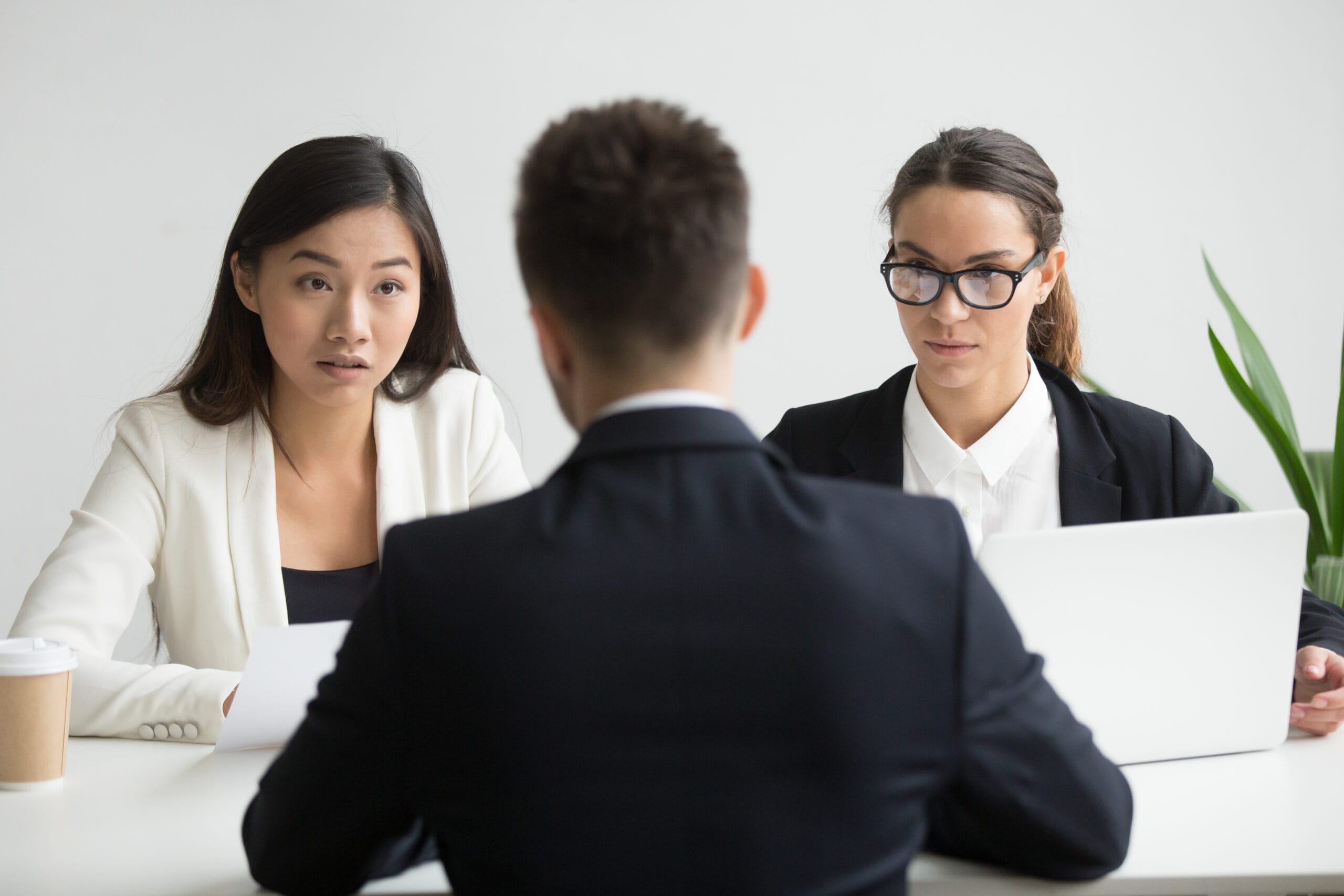 Serious unconvinced diverse hr managers interviewing male job ap